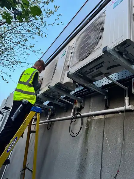 One of Elite AC North West LTD's technicians doing a commercial air conditioning installation
