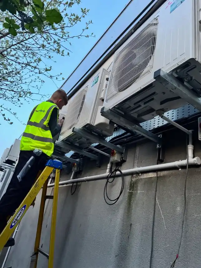 One of Elite AC North West LTD's technicians doing a commercial air conditioning installation